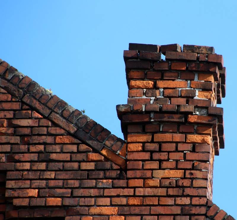 Damaged chimney on an Macomb home showing cracks and missing mortar